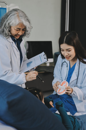 A team of doctors and nurses are working to treat a female patient in the patient's room.の写真素材