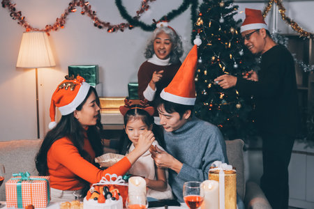 Happy family with gifts celebrating Christmas togetherの写真素材