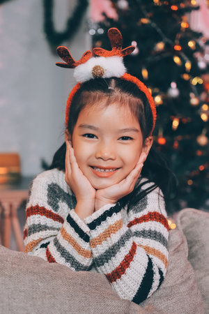 Full size photo of attractive teen girl lying floor gifts dressed green christmas outfit cozy day light home party decoration interior roomの写真素材