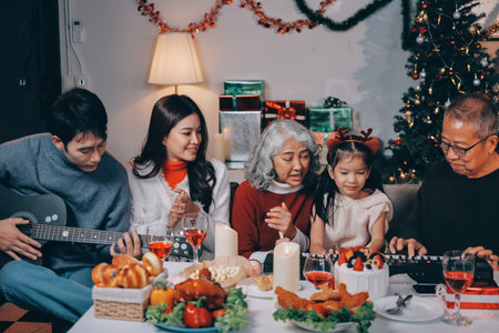 Multi-Generation Family Celebrate Christmas At Home Wearing Santa Hats And Antlers Opening Presentsの写真素材