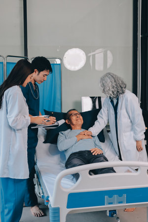 A team of doctors and nurses are working to treat a female patient in the patient's room.の写真素材
