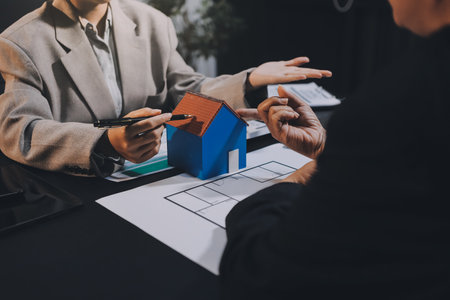 Close up Business people or Real Estate agent explain signing agreement for sale house to client. Property, Insurance, Broker concept.の写真素材