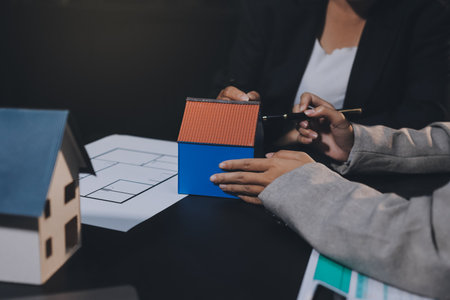 Close up Business people or Real Estate agent explain signing agreement for sale house to client. Property, Insurance, Broker concept.の写真素材