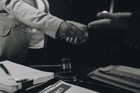 Judge gavel with Justice lawyers having team meeting at law firm background. Concepts of Law and Legal services.の写真素材