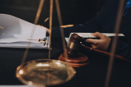 Judge gavel with Justice lawyers having team meeting at law firm background. Concepts of Law and...