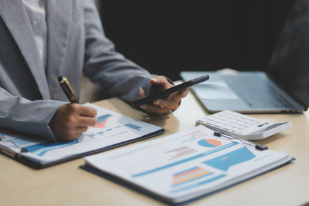 Business Documents, Auditor businesswoman checking searching document legal prepare paperwork or report for analysis TAX time,accountant Documents data contract partner deal in workplace officeの写真素材