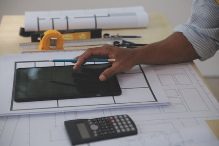 Image of engineer meeting for architectural project. working with partner and engineering tools on...