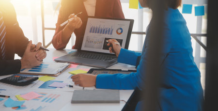 Meeting of business executives discussing analysis of the company's financial situation and business planning with partner collaboration and consultation of strategy.の写真素材