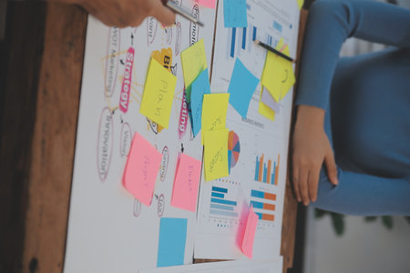 Team of business people working together in the meeting room office, teamwork background charts and...
