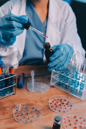 Blood test in the laboratory. Laboratory assistant working with the dispenser. Vacuum tubes with blood.の写真素材