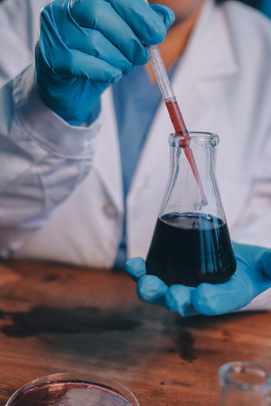 Blood test in the laboratory. Laboratory assistant working with the dispenser. Vacuum tubes with...
