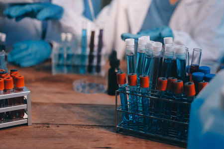 Blood test in the laboratory. Laboratory assistant working with the dispenser. Vacuum tubes with blood.の写真素材