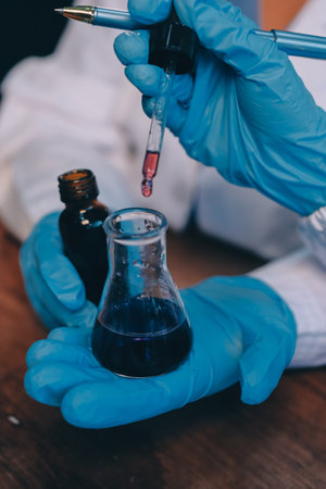 Blood test in the laboratory. Laboratory assistant working with the dispenser. Vacuum tubes with...