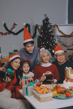 Happy family with gifts celebrating Christmas togetherの写真素材