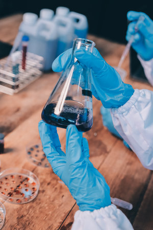 Blood test in the laboratory. Laboratory assistant working with the dispenser. Vacuum tubes with blood.の写真素材