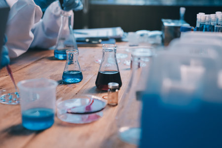 Blood test in the laboratory. Laboratory assistant working with the dispenser. Vacuum tubes with blood.の写真素材