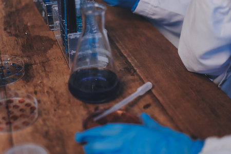 Blood test in the laboratory. Laboratory assistant working with the dispenser. Vacuum tubes with blood.の写真素材