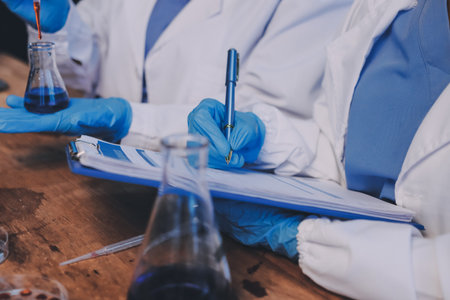 Blood test in the laboratory. Laboratory assistant working with the dispenser. Vacuum tubes with blood.の写真素材