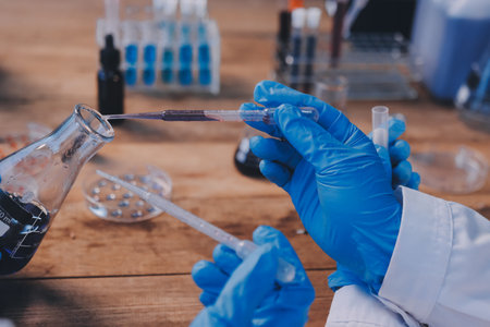 Blood test in the laboratory. Laboratory assistant working with the dispenser. Vacuum tubes with...