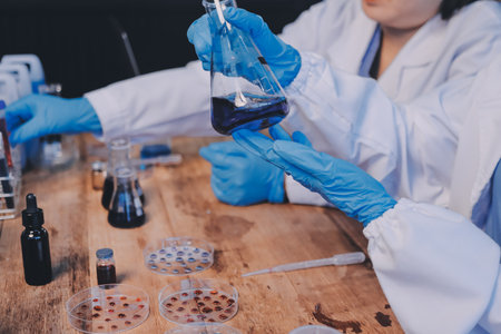 Blood test in the laboratory. Laboratory assistant working with the dispenser. Vacuum tubes with...