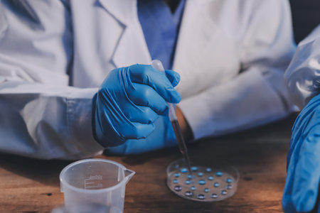 Blood test in the laboratory. Laboratory assistant working with the dispenser. Vacuum tubes with...