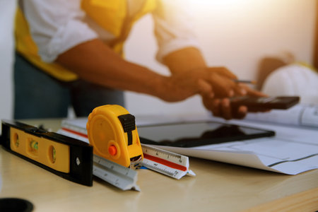 Image of engineer meeting for architectural project. working with partner and engineering tools on...