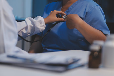 Asian female medical doctor use stethoscope to listen examine check senior elderly patientâs heartの写真素材