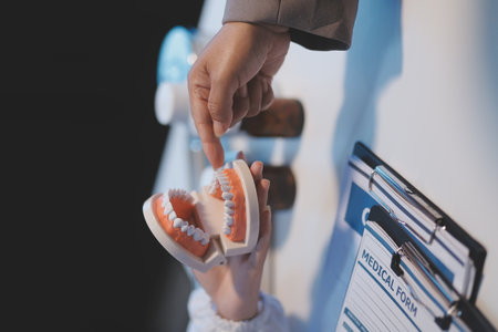 Dentist and patient discussion about planned dental treatment in dental clinic office, doctors talk and work. health care talk medical conference conceptの写真素材
