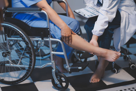 Asian young professional successful friendly female nurse in blue hospital uniform helping supporting physical therapy senior old pensioner unhealthy injury woman patient walking via four legs walker.の写真素材