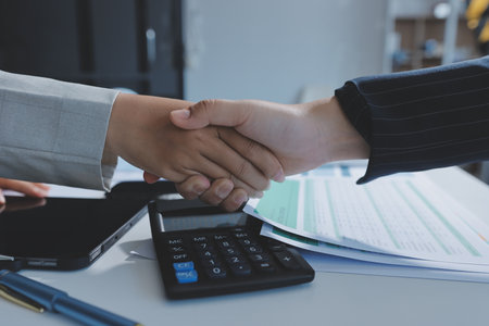 Business handshake for teamwork of business merger and acquisition,successful negotiate,hand shake,two businessman shake hand with partner to celebration partnership and business deal conceptの写真素材