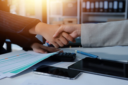 Business handshake for teamwork of business merger and acquisition,successful negotiate,hand shake,two businessman shake hand with partner to celebration partnership and business deal conceptの写真素材