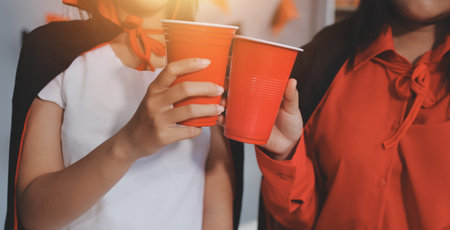 friendship, holiday and people concept - group of happy smiling friends in halloween costumes of vampire, devil, witch and cheetah at home partyの写真素材