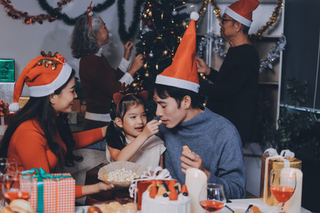Happy family with gifts celebrating Christmas togetherの写真素材
