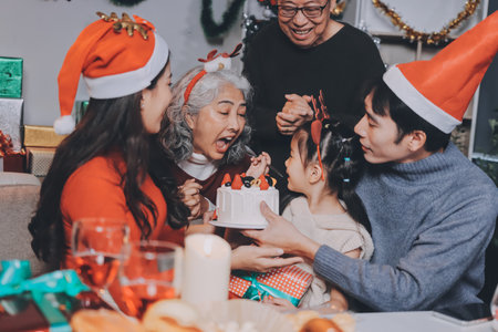 Happy family with gifts celebrating Christmas togetherの写真素材