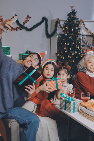 Happy family with gifts celebrating Christmas togetherの写真素材