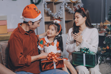 Father, mother and child celebrating Christmas.の写真素材