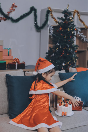 Little girl with Christmas gift at homeの写真素材