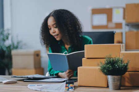 Portrait of Starting small businesses SME owners female entrepreneurs working on receipt box and check online orders to prepare to pack the boxes, sell to customers, SME business ideas online.の写真素材