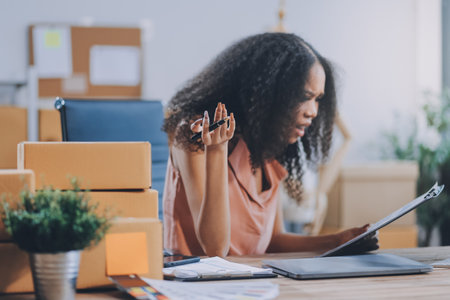 Portrait of Starting small businesses SME owners female entrepreneurs working on receipt box and check online orders to prepare to pack the boxes, sell to customers, SME business ideas online.の写真素材