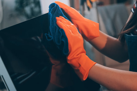Janitor wiping table in officeの写真素材