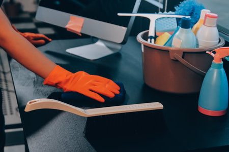 Janitor wiping table in officeの写真素材