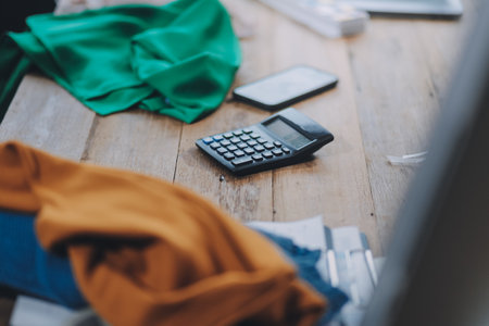 Asia people SME owner or retail fabric craft store work in artist studio home office on desk busy learn online study art class on laptop in digital dress color screen app write job idea skill on webの写真素材