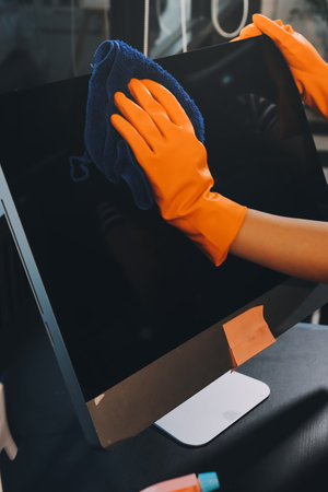 Janitor wiping table in officeの写真素材
