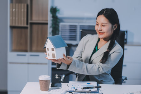 Home and real estate trading business. Real estate agent giving keys to house woman owner.の写真素材
