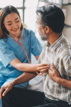 Female doctor listening to heartbeatの写真素材