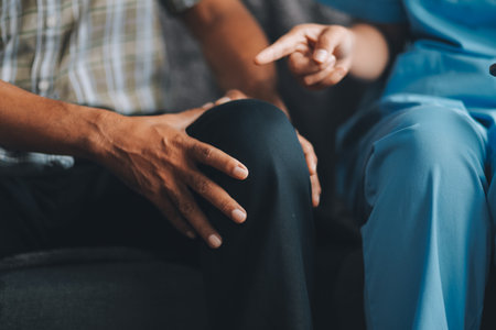 Caregiver doctor or nurse training stretching leg and knee with patient senior man for physical therapy and rehabilitation, physiotherapist assistance elderly exercising.の写真素材