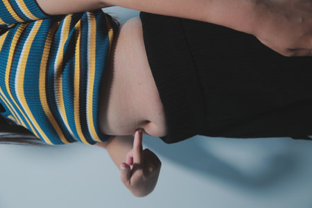 Women body belly. Woman hand holding belly. diet lifestyle concept to reduce belly and shape up stomach muscle.の写真素材