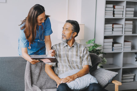 Caregiver doctor or nurse training stretching leg and knee with patient senior man for physical therapy and rehabilitation, physiotherapist assistance elderly exercising.の写真素材