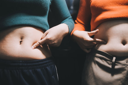 woman's hand holding belly fatの写真素材