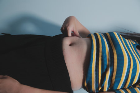 Women body fat belly. Obese woman hand holding excessive belly fat. diet lifestyle concept to reduce belly and shape up healthy stomach muscle.の写真素材
